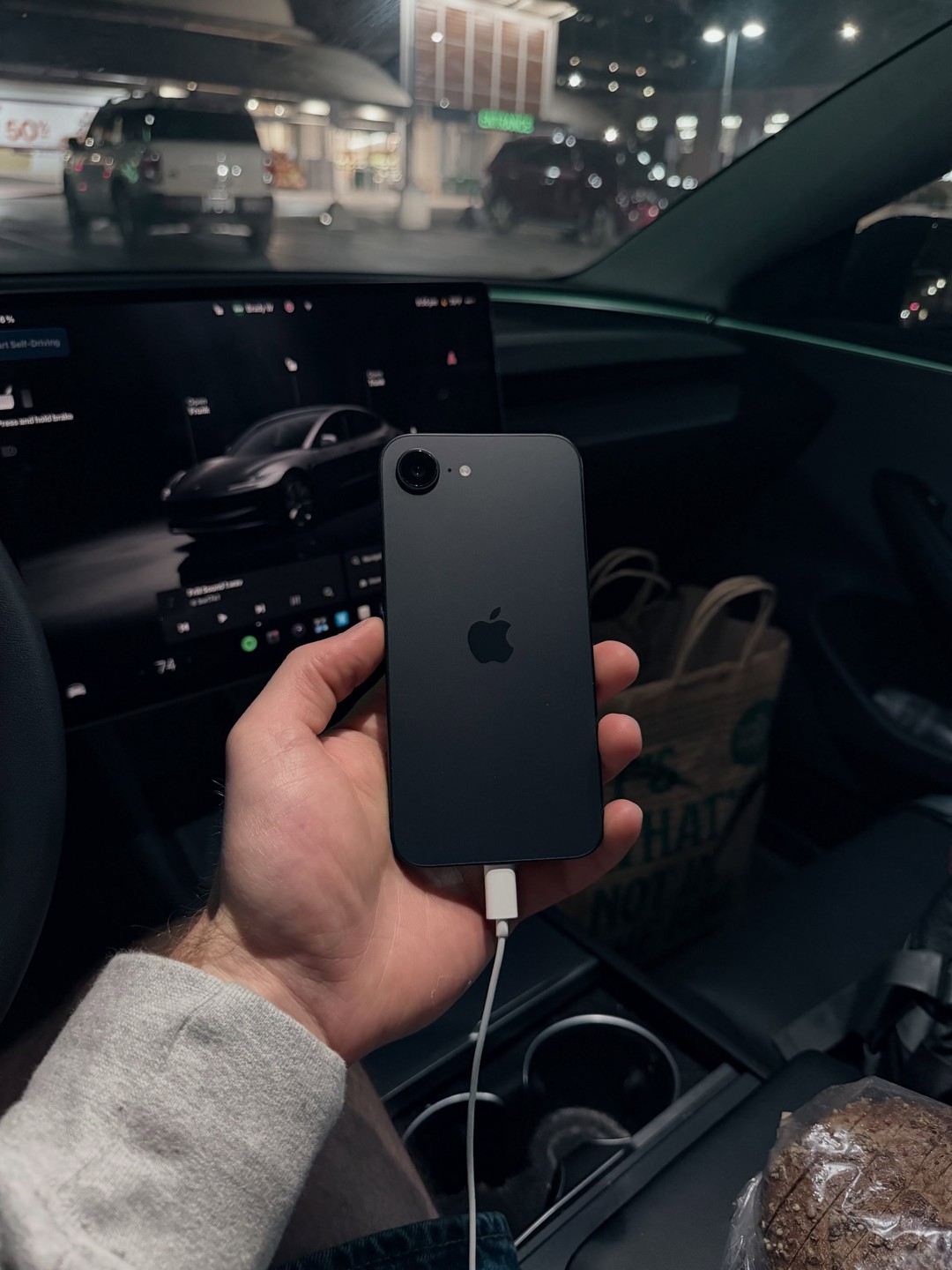 iPhone 17e photographed inside a car in Austin, Texas. Photo 1 of 2.
