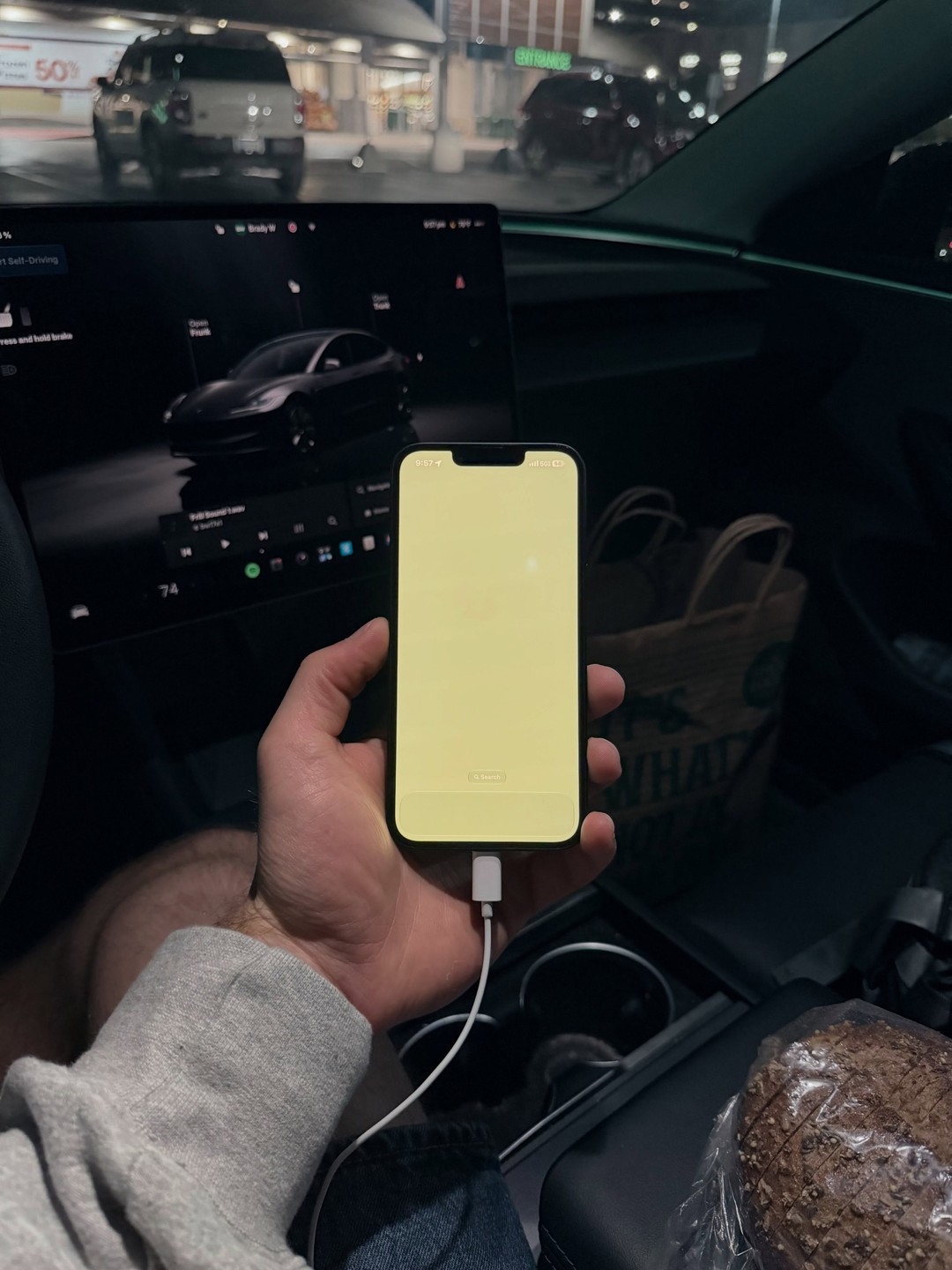 iPhone 17e photographed inside a car in Austin, Texas. Photo 2 of 2.